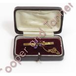 An amethyst and seed pearl bar brooch, in the form of a shamrock, stamped '9ct', 4.2g gross, cased