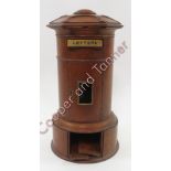 An Edwardian oak domestic letter box in the form of a pillar box having hexagonal top, slot with