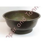 A heavy bronze bowl with low pedestal support, 36cms diam 16cms high