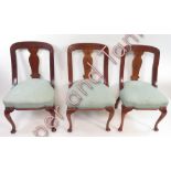 12 mahogany framed dining chairs on cabriole legs and with stuff over seats