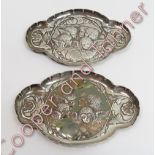 A matched pair of late Victorian silver pin trays, by William Comyns, London, 1895 and 1896, of