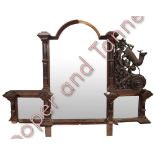 A Victorian Black Forest over mantel mirror of large proportions, the central arched glass plate