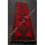 A “Turkey” runner with green/blue geometric pattern on deep red ground 355cms long 102cms wide