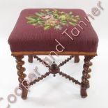 A square tapestry top stool with walnut spiral twist supports and stretchers