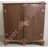 A 19th Century oak cabinet fitted with an array of 18 short drawers enclosed by a pair of doors with