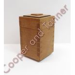 An Arts and Crafts Cotswold School oak tea caddy having lift-off stepped cover, with exposed