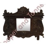 A Victorian carved oak hall mirror with lion mask pediment, central mirror in carved foliate