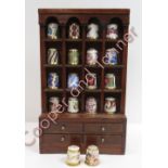 A collection of 18 Royal Crown Derby thimbles in miniature dresser display, 21cms high