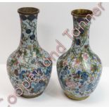 A pair of Japanese cloisonné bottle vases with trailing prunus and butterfly decoration on light