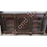 A Victorian credenza, inlaid ebony with gilt mounts and having central door enclosing shelves,