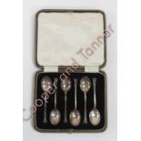 A cased set of six silver teaspoons, by J. Round, Sheffield 1926, with a horseshoe motif to the