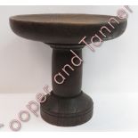 A heavy wood pedestal stand having circular top on shaped pedestal and circular base, 24cms high