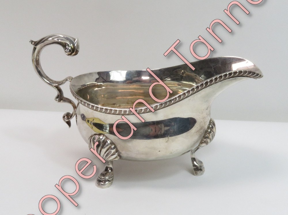 A Georgian style silver sauceboat, by Edward Barnard & Sons Ltd, London 1929, gadrooned rim, leaf