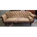 A Victorian mahogany framed settee with button back and scrolling arms with foliate decoration and