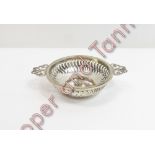 A silver two handled bon bon dish, by Synyer & Beddoes, Birmingham 1914, of circular outline with