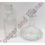 A cut glass ships decanter and stopper 25cms high together with another decanter and stopper 27cms