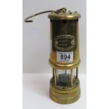 A brass miners lamp by Lamp and Limelight Company Hockley with suspension hook, 22cms high