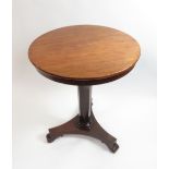 An early 19th Century mahogany circular side table on tapering octagonal support and triform base,