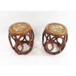 A pair of modern oriental circular hard wood stands with mother of pearl inlay decoration 45.5cms