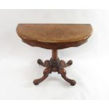 A Victorian inlaid burr walnut demi lune fold over card table on rounded pillar and four outswept