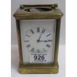 A brass cased carriage timepiece having white enamel dial, 13.5cms high with key