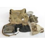 A WWII period webbing bag containing metal mess tin, enamel mug, dog tag, fork and other items