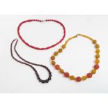 Three polished bead necklaces to include garnet, coral and carnelian, various lengths