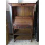 An early 20th Century oak bureau bookcase in the Arts and Crafts style having fall flap enclosing