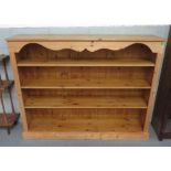 A modern pine open book shelf with decorative shaped frieze, 157cms wide 123cms high