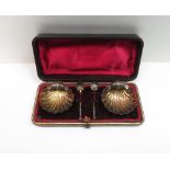 A cased pair of late Victorian silver shell salts, maker J. T., Birmingham 1895, with spoons, 22 g