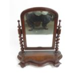 A Victorian mahogany dressing mirror with shaped base and spiral twist supports 60cms high 55cms
