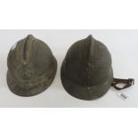 Two French WWII Adrian style metal combat helmets each having badge to the front, both lack
