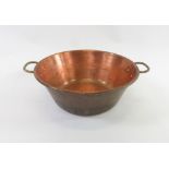 A circular copper cream pan with two brass handles 36cms diam