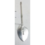 An Edwardian silver preserve spoon with flat base, one side engraved with fish crest, and with