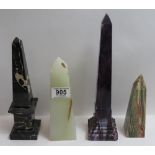 A marbled purple pressed glass obelisk 28.5cms high, a marble obelisk and two onyx obelisks