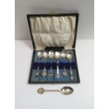 A collection of eight souvenir spoons, including a silver spoon with a Jersey Jug finial; another