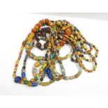 A quantity of African bead necklaces in bright colours of varying designs, and beads of glass,
