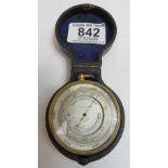 A pocket barometer and thermometer, in circular gilt brass case, the silvered metal dial inscribed