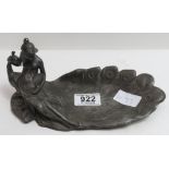 A WMF Art Nouveau pewter dish modelled as a young woman seated on a peacock looking in a hand