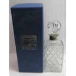 A Broadway & Co cut glass decanter of square form with stopper and silver collar, in original box,