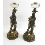 A fine pair of Victorian ormulu and bronze figural oil lamps, each circular facet cut bowl