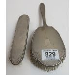 A silver backed hair brush and matching clothes brush