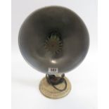 A vintage wall heater with cast metal circular wall mount and aluminium shade