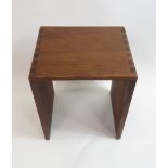 A mid century teak stool of simple curving form with attractive joint detailing