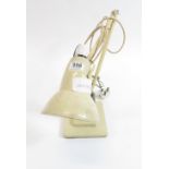 A cream painted metal angle poise lamp on stepped square base
