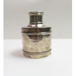 A silver tea caddy, makers mark worn, London 1912, of plain cylindrical form with an inscribed