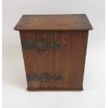 A late 19th/early 20th Century oak table top/wall cabinet, the door with decorative metal hinges and