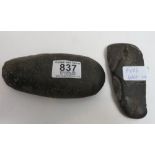 An early stone axe head, 16cms long together with another 12cms long