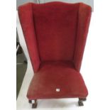 A wingback upholstered arm chair, in pink plush with studding and on claw and ball front supports