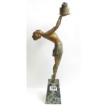 An Art Deco figural table lamp, the painted metal figure of a young woman supporting the lamp and on
